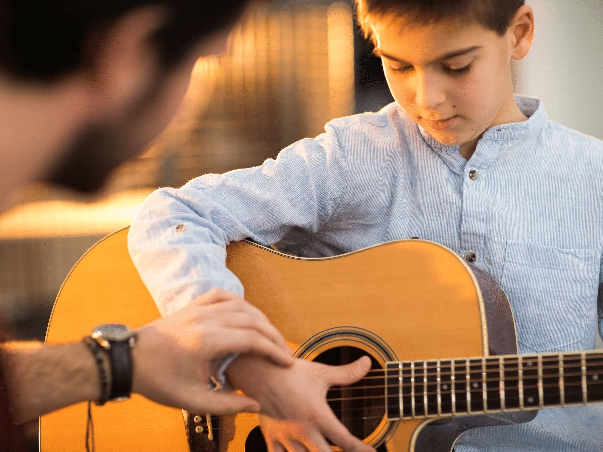 A child in a guitar lesson at Melody Magic Music Studio