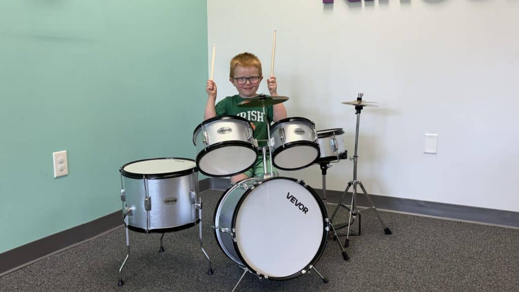 Young student playing the drum kit at Melody Magic Music Studio